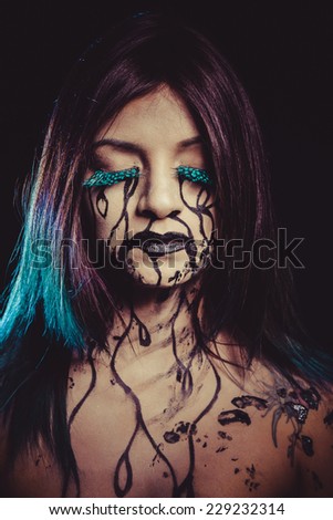 negativity concept, crying woman with tears and makeup dark light