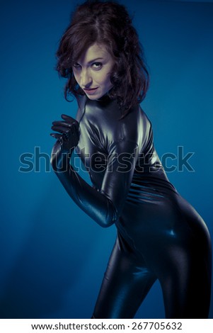Slave, sexy brunette in black latex bodysuit tight and wild poses