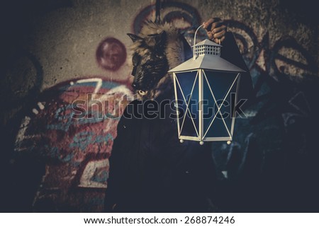 man with mask wolf and lamp with colored smoke