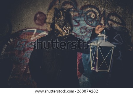 Ugly, man with mask wolf and lamp with colored smoke