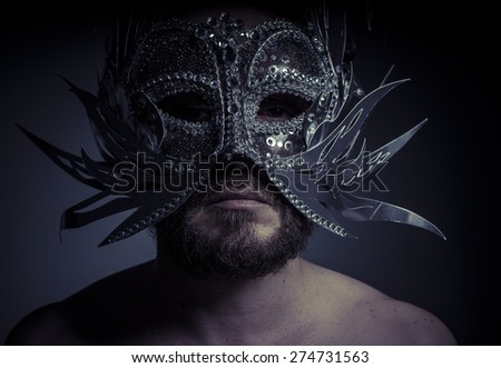 bearded man with silver mask Venetian style. Mystery and renaissance