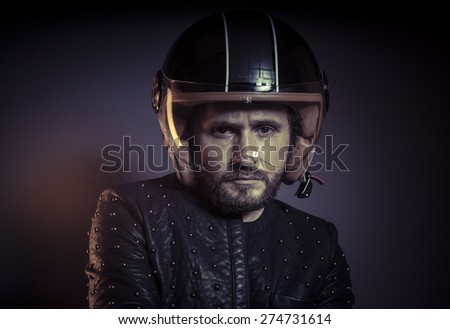 Trip, biker with motorcycle helmet and black leather jacket, metal studs