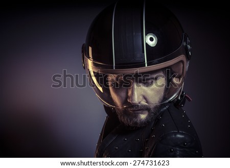 Danger, biker with motorcycle helmet and black leather jacket, metal studs