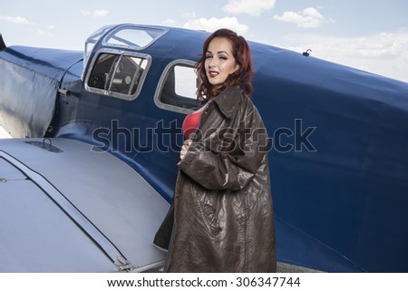 pilot, pinup dressed in era of the Second World War, beauty redheaded woman