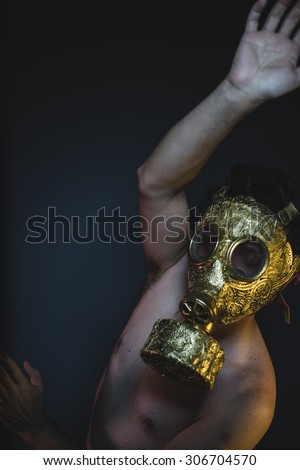 environmental, depression and danger man with golden gas mask