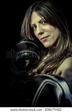 Power, strong woman athlete with boxing gloves