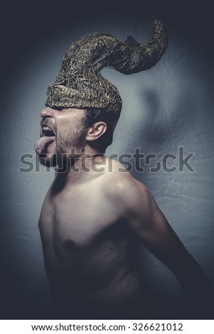 naked man with helmet warrior trumpets, and pain nightmare