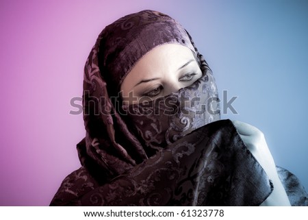 Arab veiled woman dressed lit with two lights, pink and blue