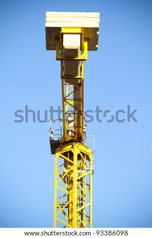 metal tower of yellow crane in a industrial area