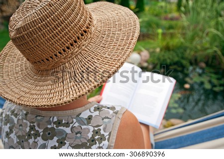Reading woman in straw hat