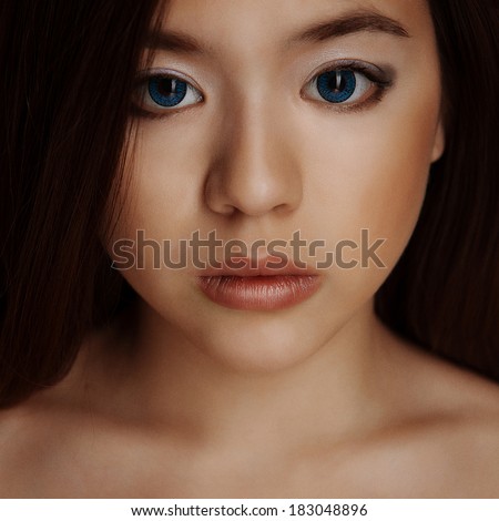 asian girl portrait with big lips and blue eyes
