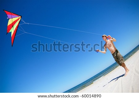 Man with a kite on a beach. Baltic sea.