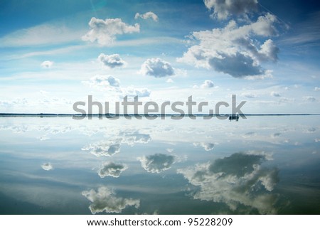 Clouds reflected in water surface. Lebsko Lake at Slowinski National Park. Poland.
