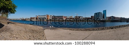 stunning Limerick cityscape panorama from Shannon bridge to Sarsfield Bridge, featuring Riverpoint buildings and river Shannon with swans (gorgeous blue sky)