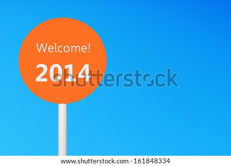 welcome 2014 sign celebrating the New Year against a vibrant blue sky (copy-space ready for your design)