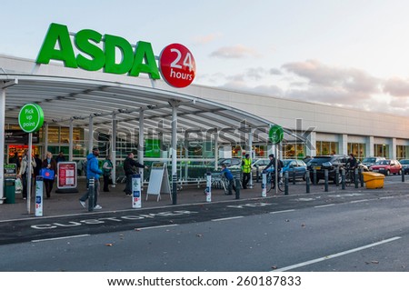 GLOUCESTER, UK - DECEMBER 07: unidentified people passing by Asda supermarket on December 07, 2011 in Gloucester, UK. Asda is the UK\'s second-largest chain by market share, with over 175,000 employees