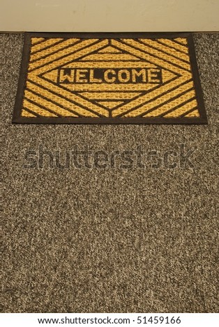 beautiful welcome home door mat on a grey carpet