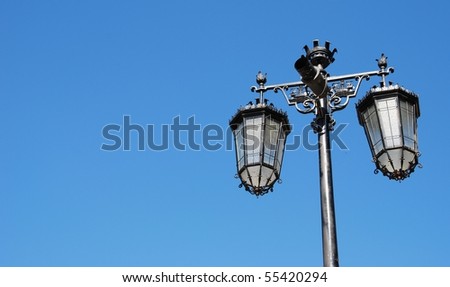 vintage lamp posts against blue sky background
