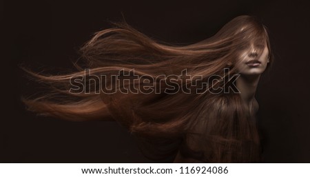 studio portrait of attractive young woman with long hair