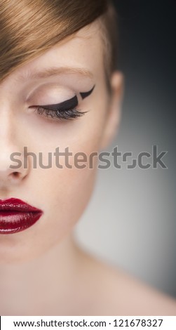 half-face studio portrait of portrait of young beauty woman with stylish makeup