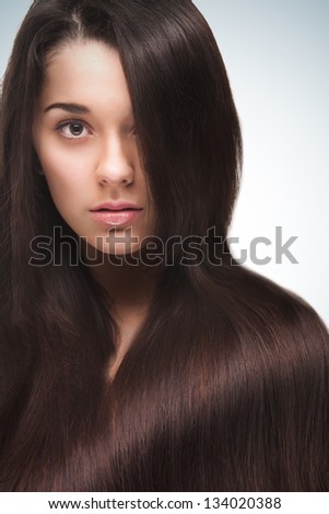 Beautiful woman with long straight hair isolated on gradient background