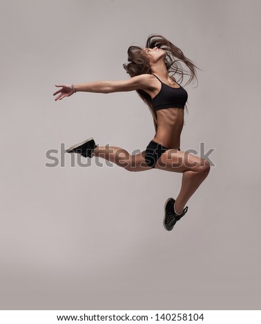 caucasian fitness woman jumping isolated on white background