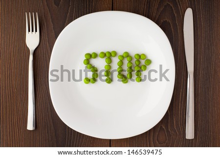 Word stop made of peas on a plate