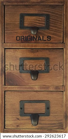 Row of little drawers with empty tag in an old furniture module