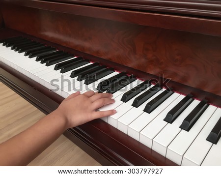 Piano playing view from right angle or Hands playing the piano