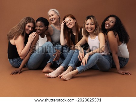 Six women of different ages sitting together in studio on brown background. Multi-ethnic group of diverse females having good times. Foto stock © 