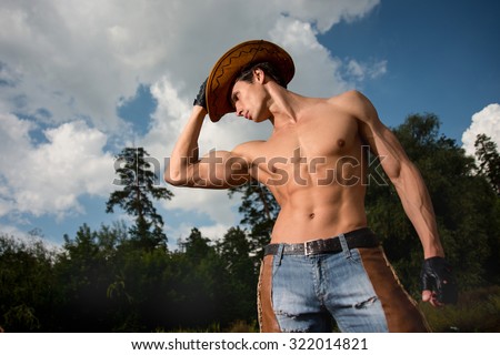 sporty, athletic, muscular sexy man in a cowboy outfit