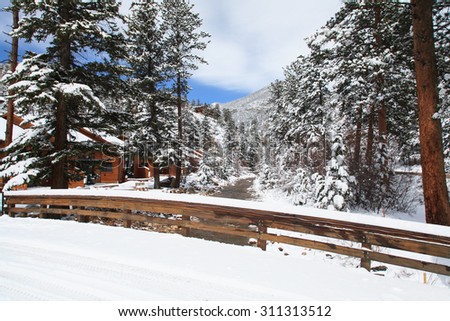 Wooden bridge and cabins covered by snow, Mountain National Park in winter, Colorado