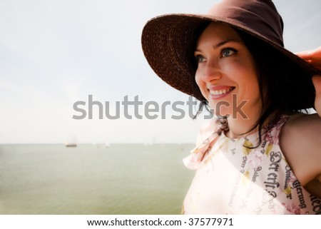 Young women with summer hat and summer glasses smiling