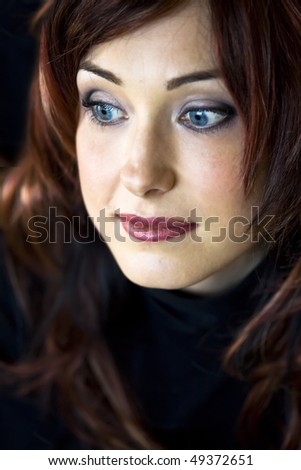 Closeup Portrait of handsome woman with blue eyes looking to the side