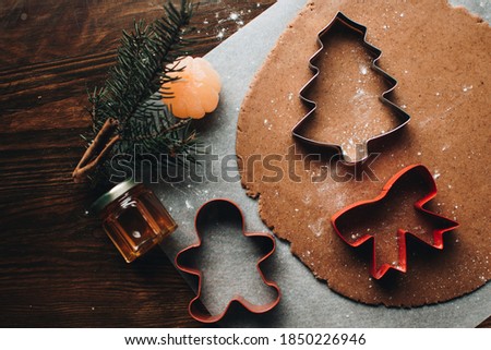 Similar – Image, Stock Photo Gingerbread cookies dough cut in different shapes on a blue table. Baking Christmas cookies