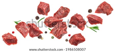 Falling diced beef meet, cubes of raw beef with rosemary isolated on white background