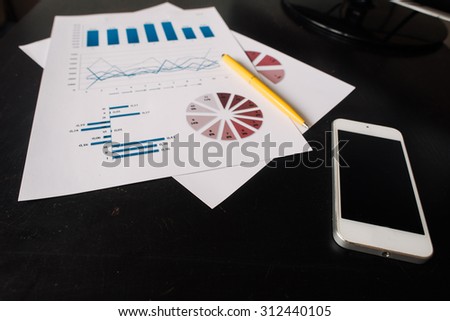 financial and business color charts and graphs on the table