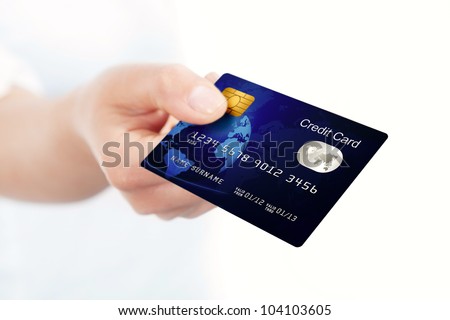 closeup of blue credit card holded by hand. focus on card