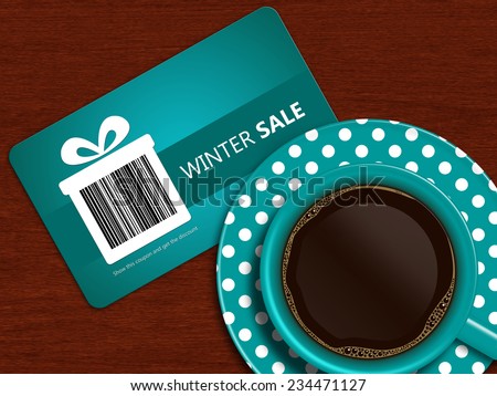 cup of coffee with winter sale coupon on wooden table