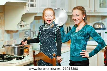 Happy woman and child preparing food together