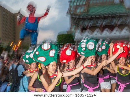 TAIPEI, TAIWAN - OCTOBER 19, 2013: Dream Community  held it\'s annual Carnival Parade in the streets. Aboriginal children\'s drumming teams, covered in feathers and glitter, marched along the streets.