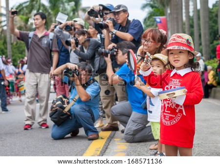 TAIPEI, TAIWAN - OCTOBER 19, 2013: Dream Community held it\'s annual Carnival Parade in the streets. Aboriginal children\'s drumming teams, covered in feathers and glitter, marched along the streets.