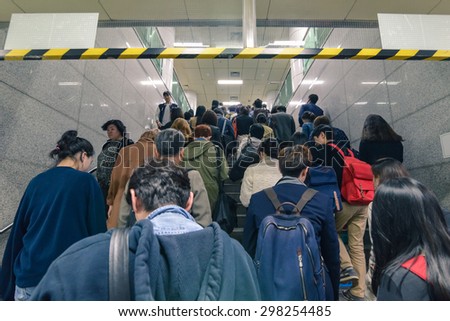 SEOUL, SOUTH KOREA - CIRCA APRIL 2014: people rush on the stairs to the metro entrance in the evening in Seoul circa 2014.
