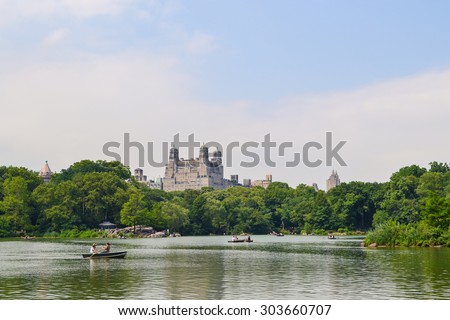NEW YORK, USA - CIRCA JUNE 2011: People ride boats on the pond among trees in Central Park, New York City, USA
