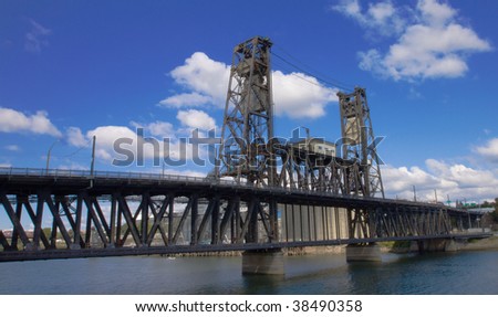 Old Steel draw bridge with blue sky and white cloud background