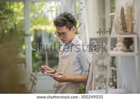 man holding a chocolate cake in vintage room