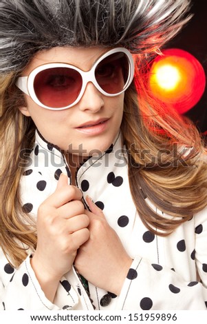 Beautiful woman with white sunglasses and hairy hat, dots jacket