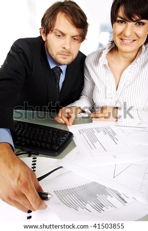 business couple is making an analyses looking at graphics