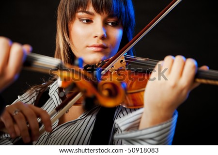 portrait of a beautiful young violinist playing  violin