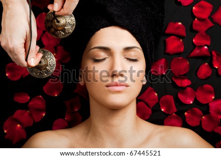 Close-up of beautiful female receiving energy sound massage at spa
